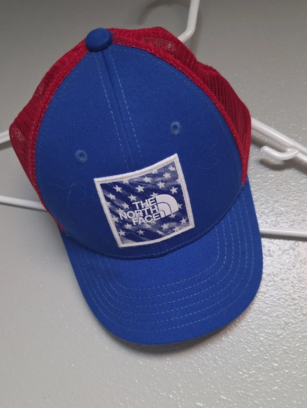 The North Face Kids Royal Blue and Red Mesh Trucker Hat